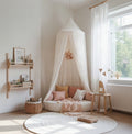 Children's bedroom with a canopy over a bed, soft lighting, and decorative elements.