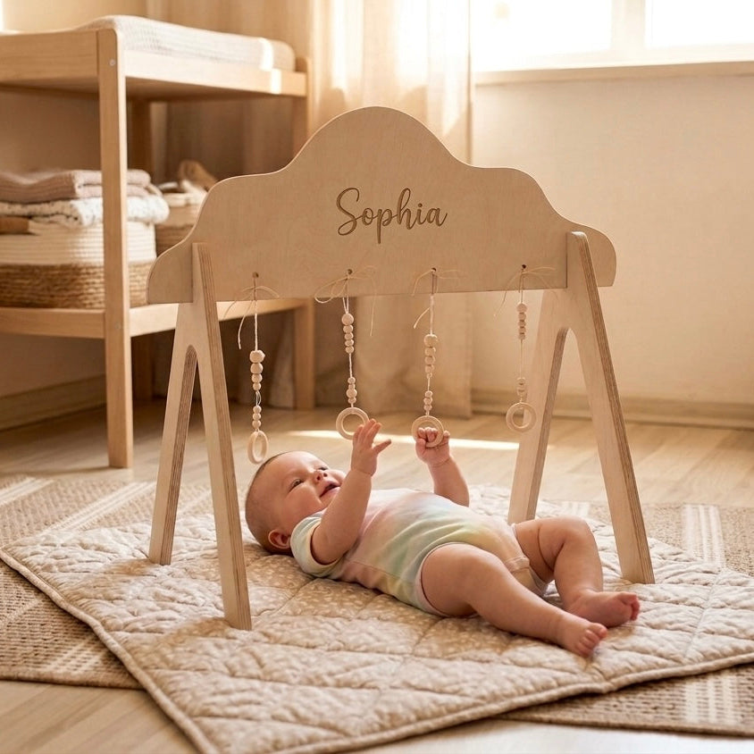 Baby playing with a wooden baby gym named 'Sophia' in a nursery.