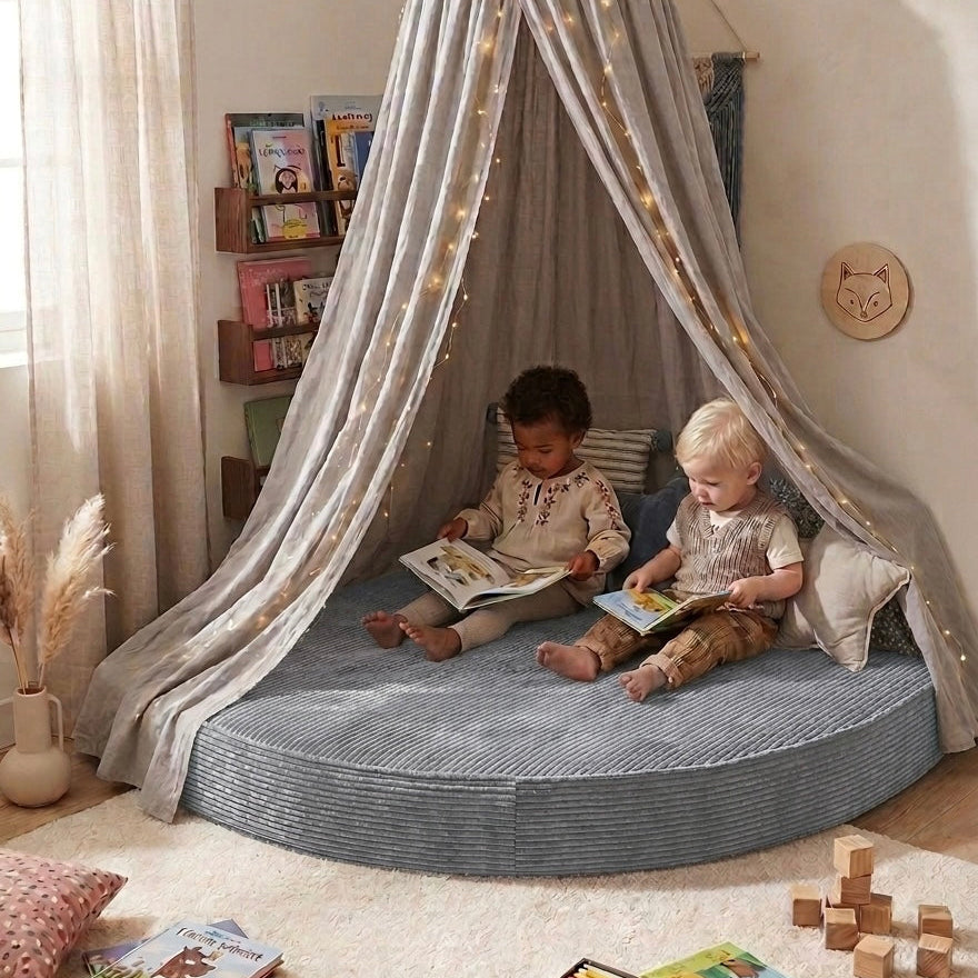 Two children reading books inside a circular reading nook with a canopy in a cozy room.
