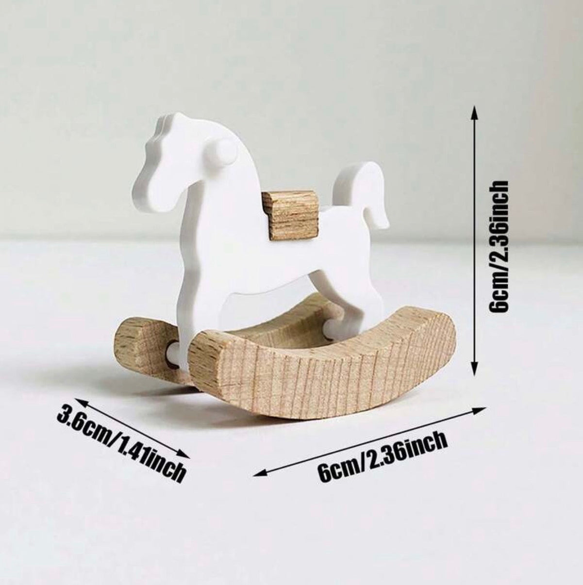 White rocking horse toy with dimensions indicated on a white background