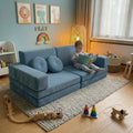 Child reading a book on a blue play couch in a cozy toddlers room.