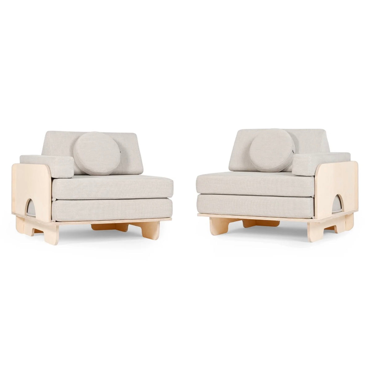 Two modern low-profile play couches with light beige upholstered seats and backs, circular back cushions, and natural wood side panels and legs, shown on a plain white background.