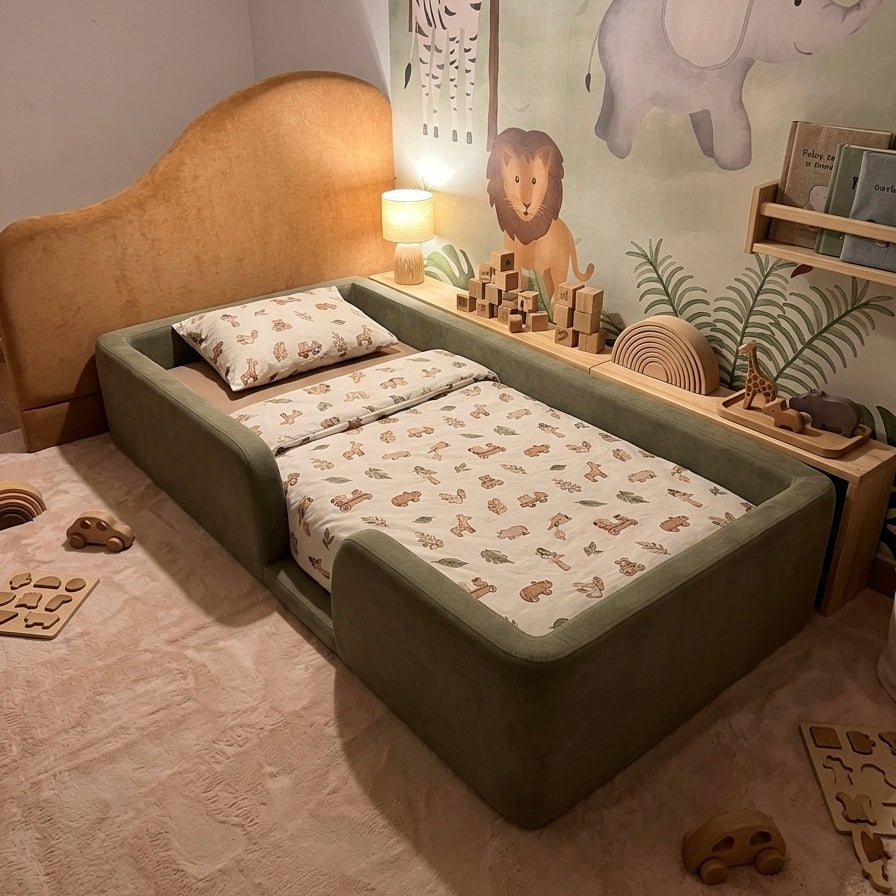 Children's bedroom with a green toddler floor bed, lion wall decor, and elephant wall art.