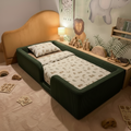 Children's room with a green toddler floor bed, toys, and safari wall decorations.