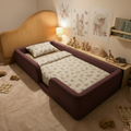 Children's bedroom with a maroon linen floor bed, toys, and wall decorations.