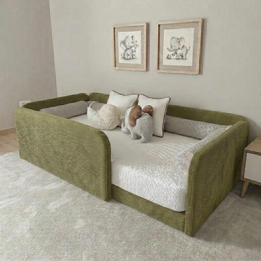Green kids bed with white cushion in a room with framed pictures on the wall.