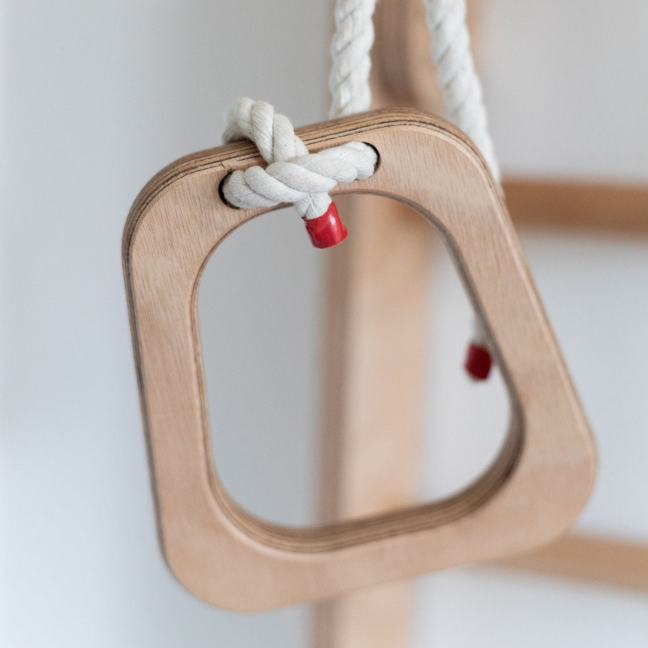 Wooden ring handle with a rope on a white background