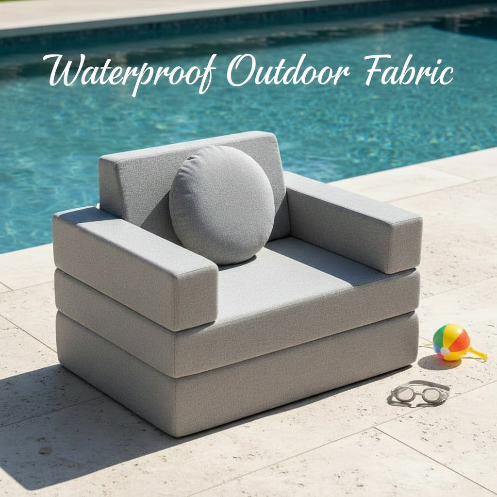 A grey upholstered play couch by a pool.