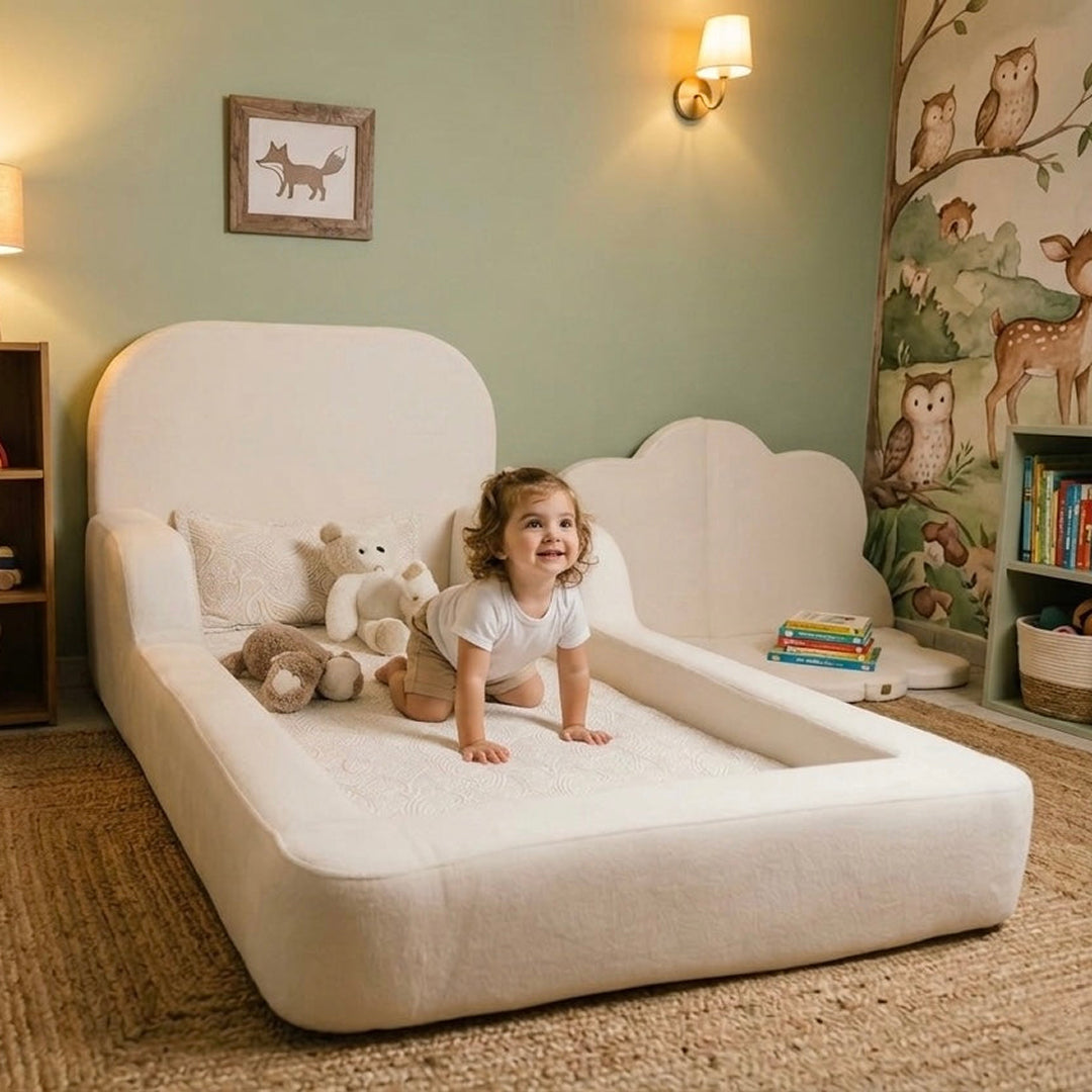 Child playing on a cloud-shaped bed in a room with a wall mural of animals.